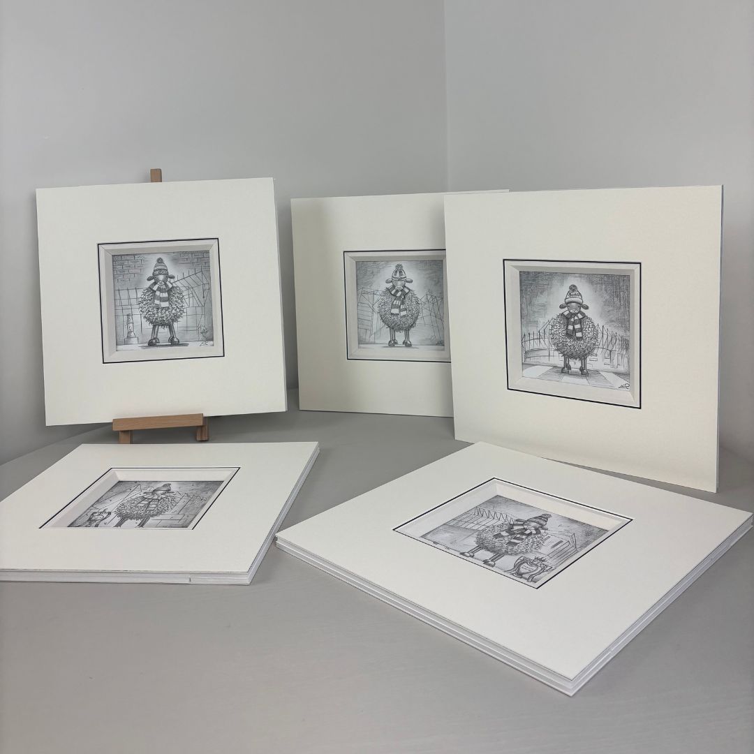 Lucy Pittaway original sketch collection displayed in mounts, featuring football sheep artwork and countryside scenes, ready for framing