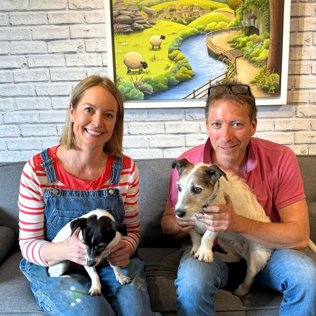 Lucy Pittaway and Julian Norton, The Yorkshire Vet, sitting on a sofa with their jack russells.