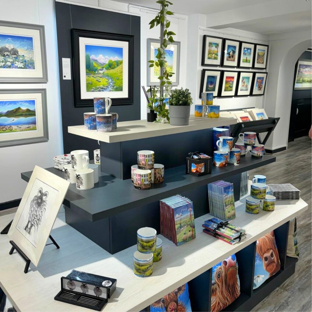 Inside the Bowness on Windermere gallery showcasing Lucy Pittaway art and merchandise.