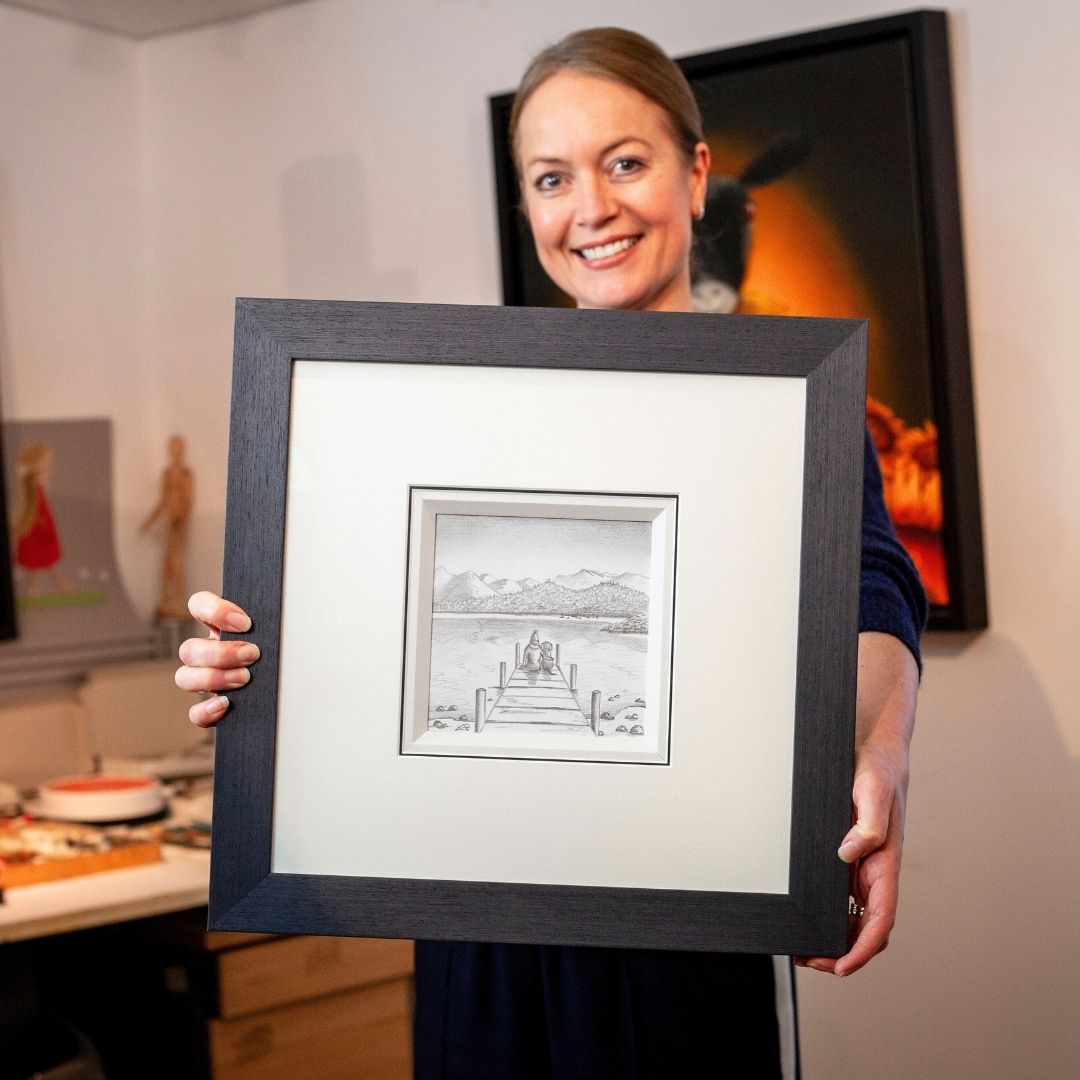 Lucy Pittaway holding one of eight new original sketches now available.